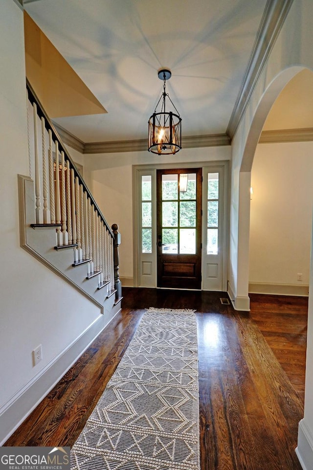 1178 Chambord Way NE, Brookhaven, GA 30319 - entrance foyer featuring arched walkways, wood finished floors, crown molding, baseboards, and a chandelier