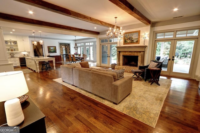 1178 Chambord Way NE, Brookhaven, GA 30319 - living room with french doors, a chandelier, plenty of natural light, dark wood-type flooring, and beamed ceiling