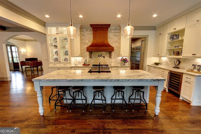 1178 Chambord Way NE, Brookhaven, GA 30319 - kitchen with wine cooler, custom range hood, a sink, backsplash, and white cabinets