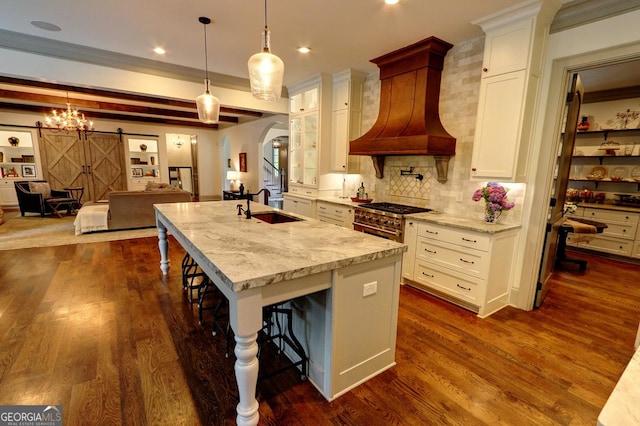 1178 Chambord Way NE, Brookhaven, GA 30319 - kitchen featuring a sink, tasteful backsplash, a breakfast bar area, an island with sink, and dark wood finished floors