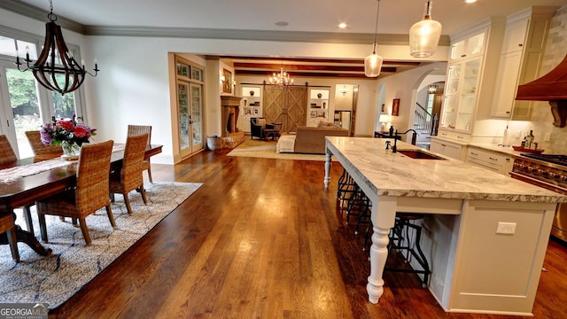 1178 Chambord Way NE, Brookhaven, GA 30319 - kitchen with a chandelier, a sink, a kitchen breakfast bar, a center island with sink, and dark wood finished floors