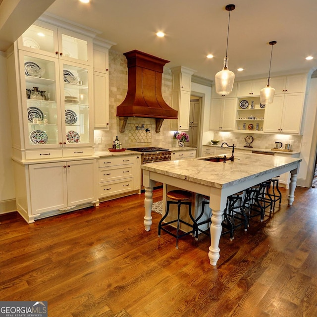 1178 Chambord Way NE, Brookhaven, GA 30319 - kitchen featuring custom range hood, a kitchen bar, white cabinetry, open shelves, and recessed lighting
