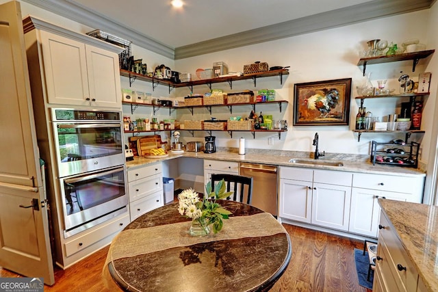 1178 Chambord Way NE, Brookhaven, GA 30319 - kitchen with stainless steel appliances, open shelves, a sink, crown molding, and wood finished floors