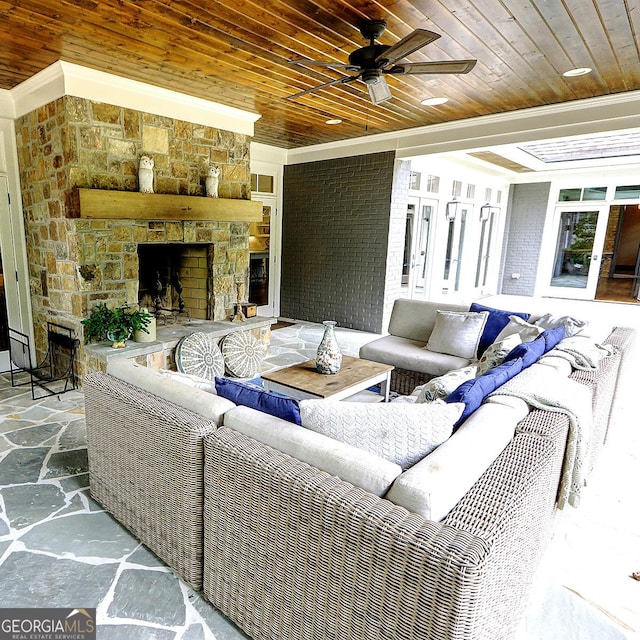 1178 Chambord Way NE, Brookhaven, GA 30319 - living area featuring a fireplace, stone floors, wooden ceiling, a ceiling fan, and ornamental molding