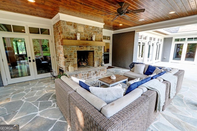 1178 Chambord Way NE, Brookhaven, GA 30319 - living room with french doors, wooden ceiling, stone flooring, a ceiling fan, and a stone fireplace