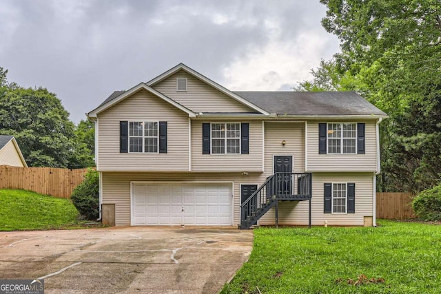 275 Mountain Way, Covington, GA 30016 - split foyer home featuring concrete driveway and an attached garage