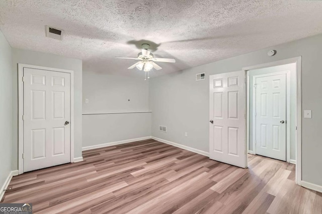 275 Mountain Way, Covington, GA 30016 - unfurnished room featuring a ceiling fan, light wood-style floors, and a textured ceiling