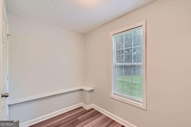 275 Mountain Way, Covington, GA 30016 - spare room featuring wood finished floors and a textured ceiling