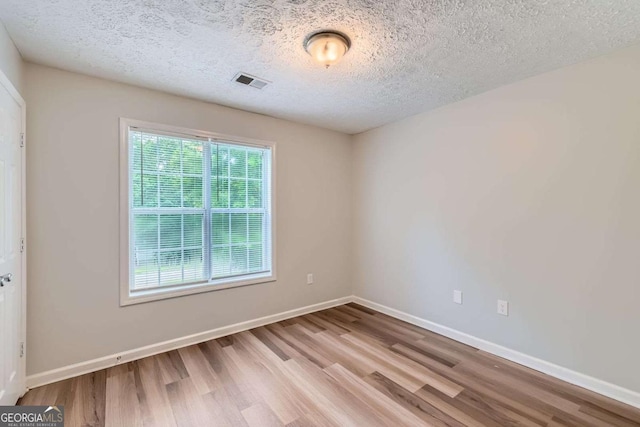275 Mountain Way, Covington, GA 30016 - spare room featuring wood finished floors and a textured ceiling