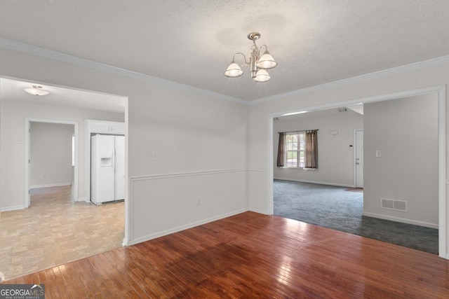 225 Chinns Way, Hampton, GA 30228 - unfurnished room with a chandelier, baseboards, crown molding, light wood-type flooring, and a textured ceiling