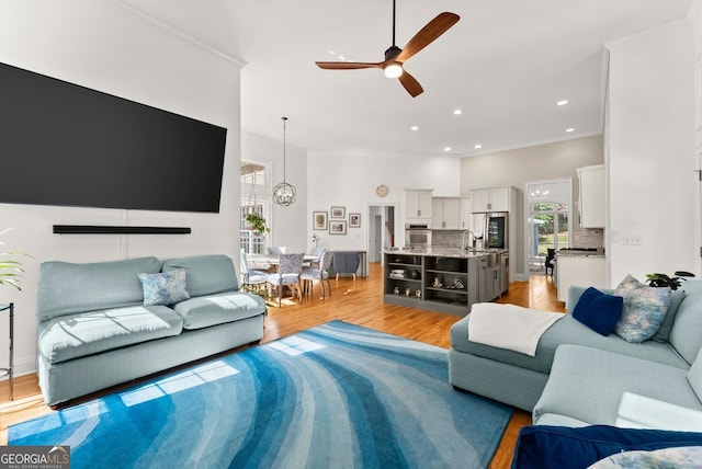 1421 Lane Creek Dr, Bishop, GA 30621 - living room featuring crown molding, a ceiling fan, light wood-style flooring, recessed lighting, and a chandelier