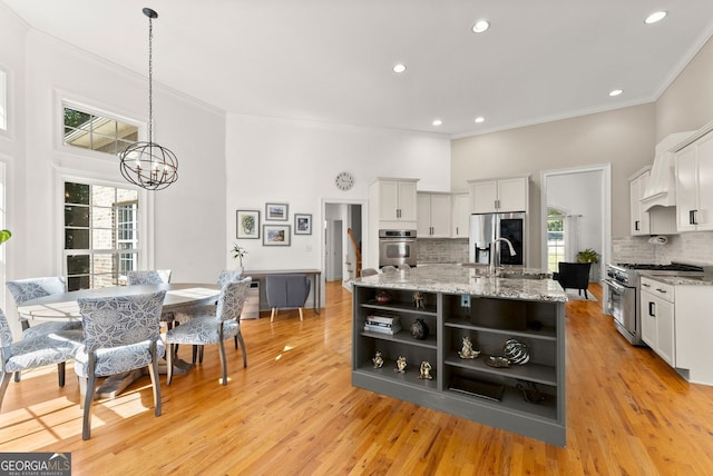 1421 Lane Creek Dr, Bishop, GA 30621 - kitchen featuring appliances with stainless steel finishes, open shelves, a sink, decorative backsplash, and white cabinetry