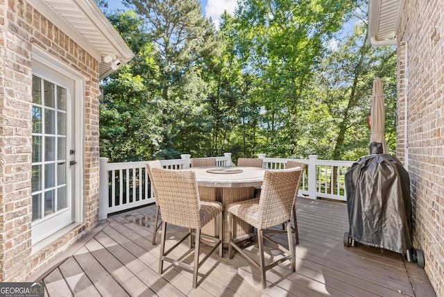 1421 Lane Creek Dr, Bishop, GA 30621 - wooden deck featuring outdoor dining area and view of scattered trees