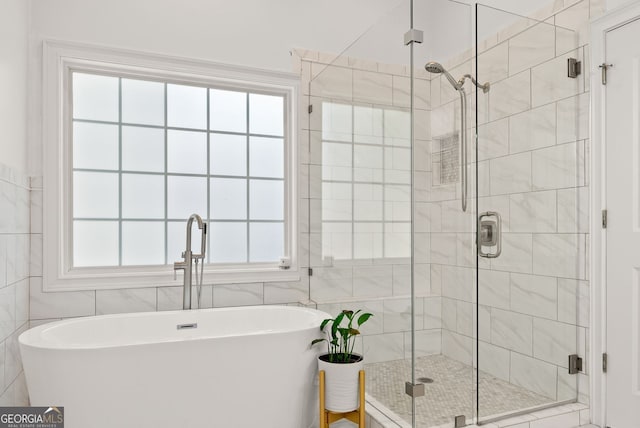1421 Lane Creek Dr, Bishop, GA 30621 - full bathroom featuring tile walls, a freestanding tub, a stall shower, and plenty of natural light