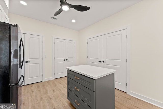 1421 Lane Creek Dr, Bishop, GA 30621 - kitchen with refrigerator with ice dispenser, gray cabinetry, light wood-style flooring, a kitchen island, and baseboards