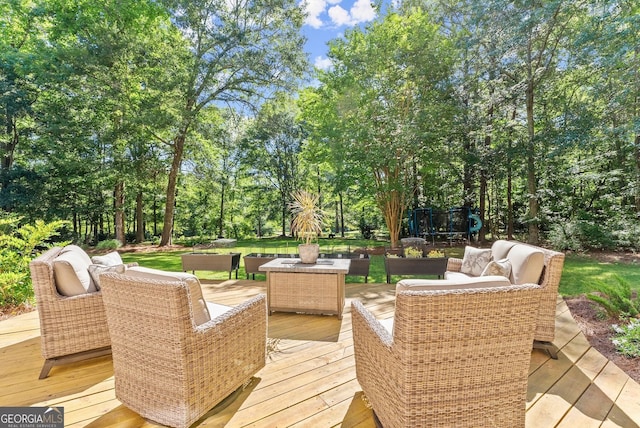 1421 Lane Creek Dr, Bishop, GA 30621 - wooden deck featuring outdoor lounge area, view of scattered trees, and a playground