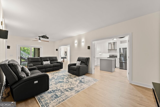 1421 Lane Creek Dr, Bishop, GA 30621 - living area featuring light wood finished floors, a ceiling fan, and baseboards