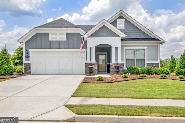 411 Southbridge Pass, Peachtree City, GA 30269 - craftsman-style house featuring stone siding, driveway, a front yard, and a garage