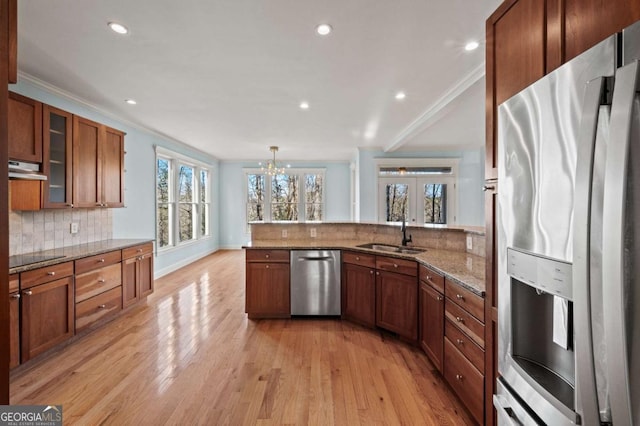 100 Oboe Ct, Ellijay, GA 30540 - kitchen featuring stainless steel appliances, a sink, crown molding, a peninsula, and brown cabinets