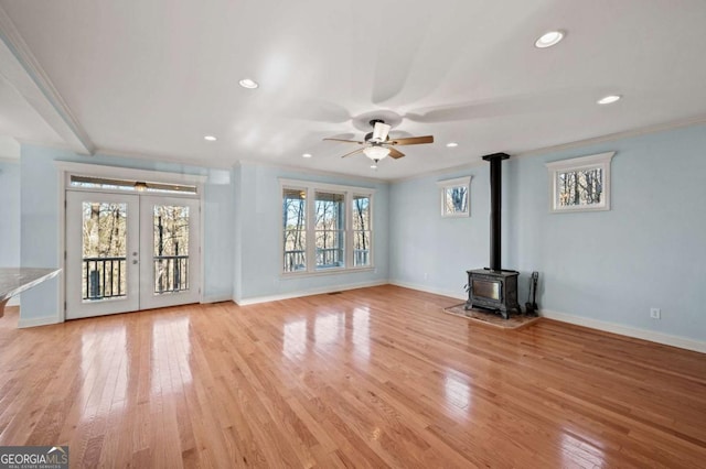 100 Oboe Ct, Ellijay, GA 30540 - unfurnished living room featuring a ceiling fan, a wood stove, baseboards, recessed lighting, and light wood finished floors