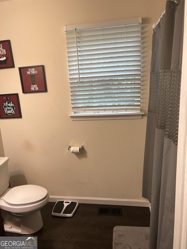 1063 NW Cato St NW, Atlanta, GA 30318 - bathroom featuring wood finished floors and curtained shower