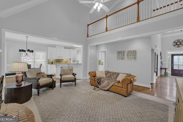 1304 Swallows Walk, Grayson, GA 30017 - living room featuring a chandelier, high vaulted ceiling, ceiling fan, light wood-type flooring, and baseboards