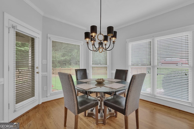 1304 Swallows Walk, Grayson, GA 30017 - dining area featuring a chandelier, ornamental molding, light wood finished floors, and plenty of natural light