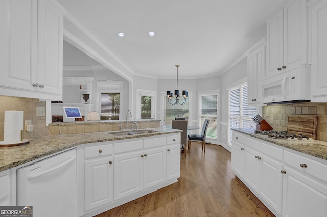 1304 Swallows Walk, Grayson, GA 30017 - kitchen featuring white appliances, a sink, healthy amount of natural light, a chandelier, and recessed lighting