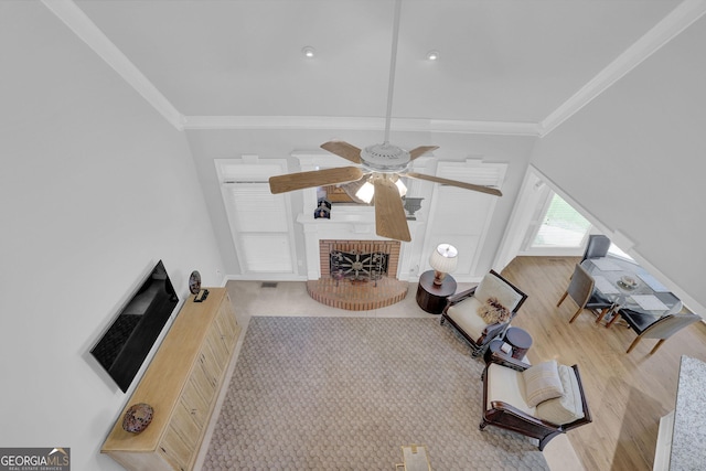 1304 Swallows Walk, Grayson, GA 30017 - living room featuring ornamental molding, a ceiling fan, wood finished floors, a brick fireplace, and baseboards