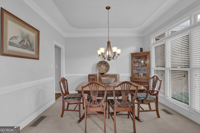 1304 Swallows Walk, Grayson, GA 30017 - dining space featuring light carpet, a chandelier, a raised ceiling, and ornamental molding