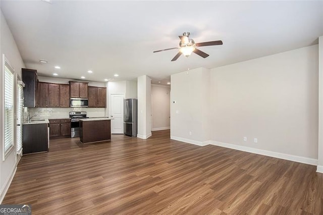 422 Dublin Way, Dallas, GA 30132 - kitchen with stainless steel appliances, open floor plan, ceiling fan, dark wood-type flooring, and baseboards