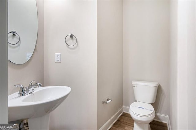 422 Dublin Way, Dallas, GA 30132 - bathroom featuring toilet, baseboards, wood finished floors, and a sink