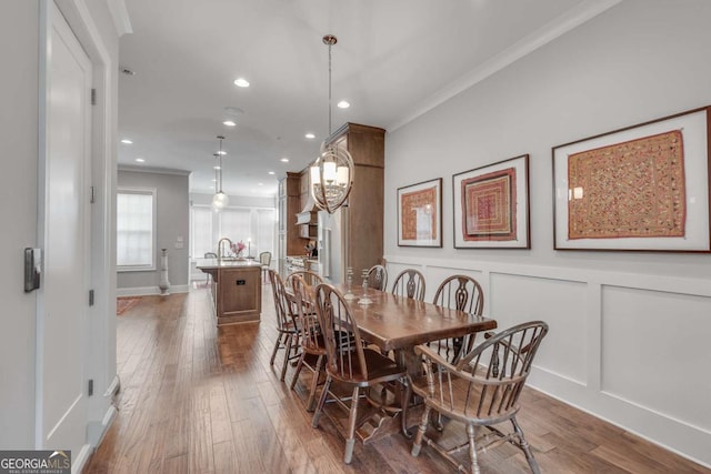345 Glen Iris Dr NE Unit 3, Atlanta, GA 30312 - dining room with crown molding, hardwood / wood-style flooring, recessed lighting, and a decorative wall