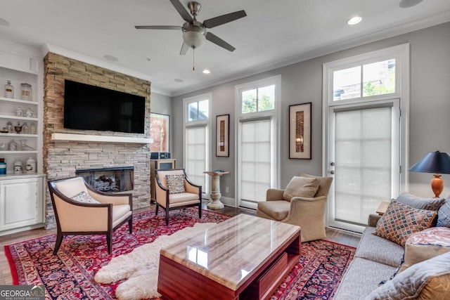345 Glen Iris Dr NE Unit 3, Atlanta, GA 30312 - living room with ornamental molding, wood finished floors, a stone fireplace, a ceiling fan, and recessed lighting