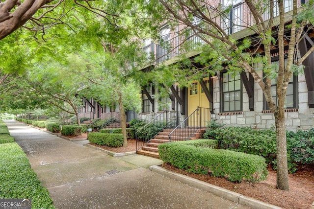 345 Glen Iris Dr NE Unit 3, Atlanta, GA 30312 - view of exterior entry with a balcony and stone siding