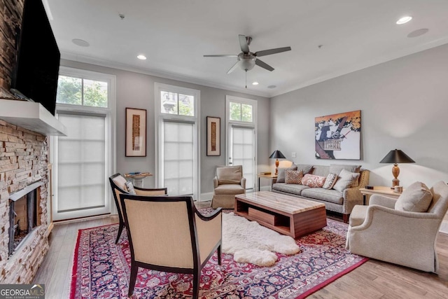 345 Glen Iris Dr NE Unit 3, Atlanta, GA 30312 - living room with ornamental molding, healthy amount of natural light, wood finished floors, a stone fireplace, and ceiling fan