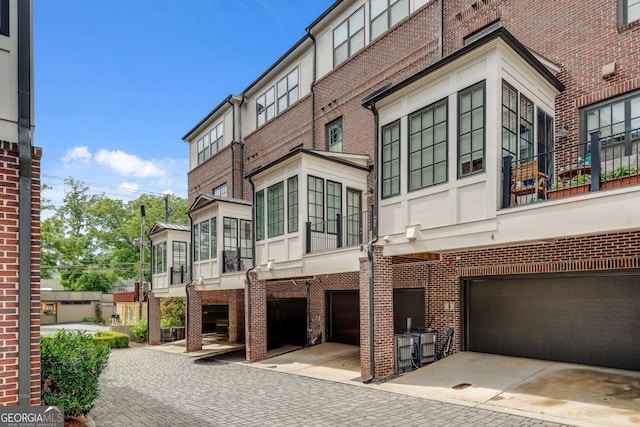 345 Glen Iris Dr NE Unit 3, Atlanta, GA 30312 - view of building exterior with an attached garage and driveway