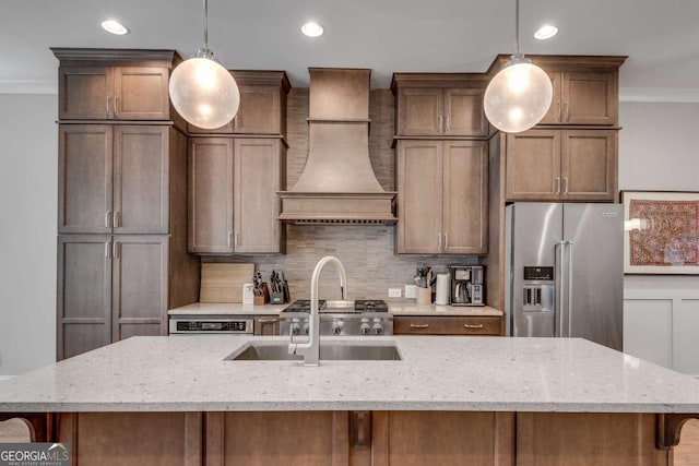 345 Glen Iris Dr NE Unit 3, Atlanta, GA 30312 - kitchen with high end refrigerator, a center island with sink, custom range hood, backsplash, and ornamental molding