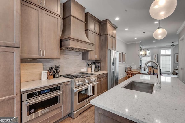 345 Glen Iris Dr NE Unit 3, Atlanta, GA 30312 - kitchen with high end appliances, premium range hood, crown molding, tasteful backsplash, and light stone counters