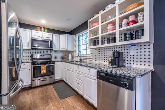 2849 Crescendo Dr, Atlanta, GA 30318 - kitchen featuring stainless steel appliances, a sink, open shelves, stone counters, and white cabinetry