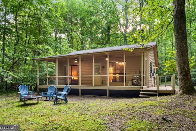62 Nocona Trl, Ellijay, GA 30536 - back of house featuring a fire pit, a sunroom, and a wooden deck