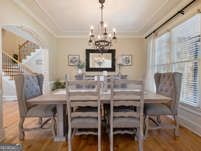 70 Baker Pond Ct, Jefferson, GA 30549 - dining space with a chandelier, healthy amount of natural light, light wood-style floors, and crown molding