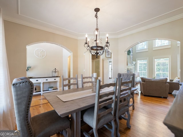 70 Baker Pond Ct, Jefferson, GA 30549 - dining space featuring arched walkways, a chandelier, crown molding, and wood finished floors