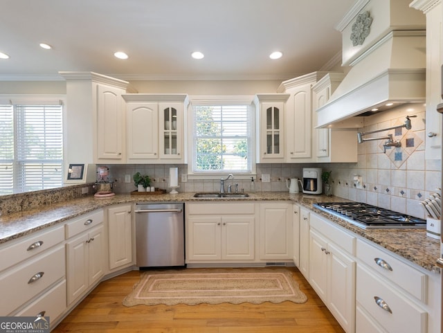 70 Baker Pond Ct, Jefferson, GA 30549 - kitchen featuring stainless steel appliances, a sink, crown molding, glass insert cabinets, and tasteful backsplash
