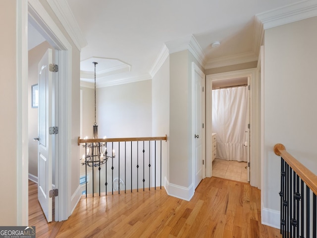 70 Baker Pond Ct, Jefferson, GA 30549 - corridor with wood finished floors, an upstairs landing, baseboards, a chandelier, and crown molding