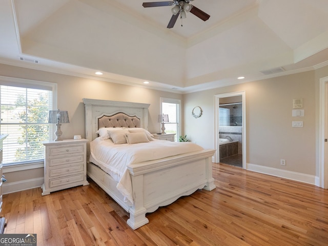 70 Baker Pond Ct, Jefferson, GA 30549 - bedroom featuring a raised ceiling, light wood-style floors, crown molding, baseboards, and connected bathroom