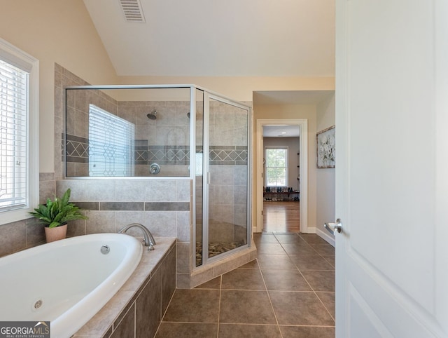 70 Baker Pond Ct, Jefferson, GA 30549 - full bathroom featuring a bath, a stall shower, tile patterned flooring, and lofted ceiling