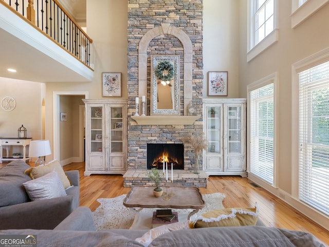 70 Baker Pond Ct, Jefferson, GA 30549 - living room with a fireplace, a high ceiling, wood finished floors, and baseboards