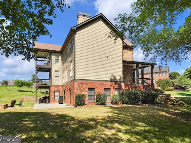 70 Baker Pond Ct, Jefferson, GA 30549 - view of side of property with a balcony, brick siding, a lawn, a patio area, and a chimney