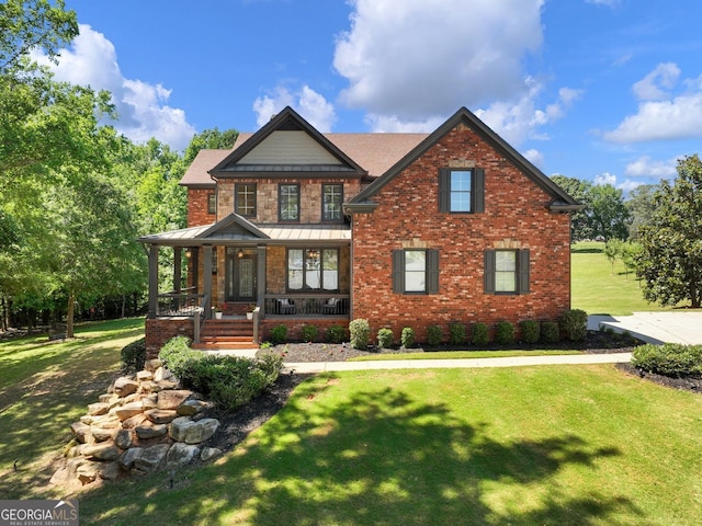 70 Baker Pond Ct, Jefferson, GA 30549 - view of front of property with a porch, a front yard, a standing seam roof, and brick siding